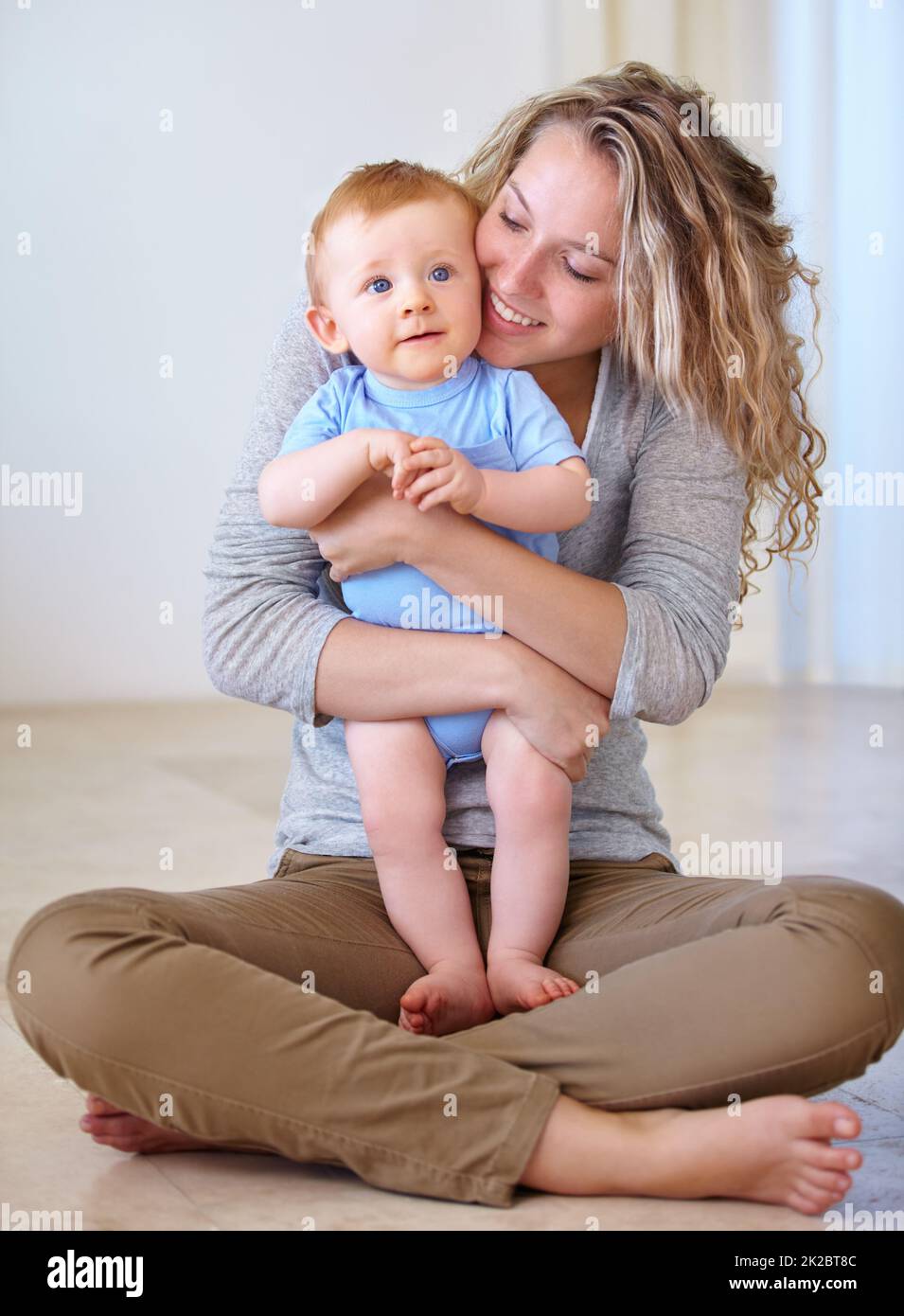 Shes so proud of her boy. Shot of an attarctive young woman and her adorable son. Stock Photo