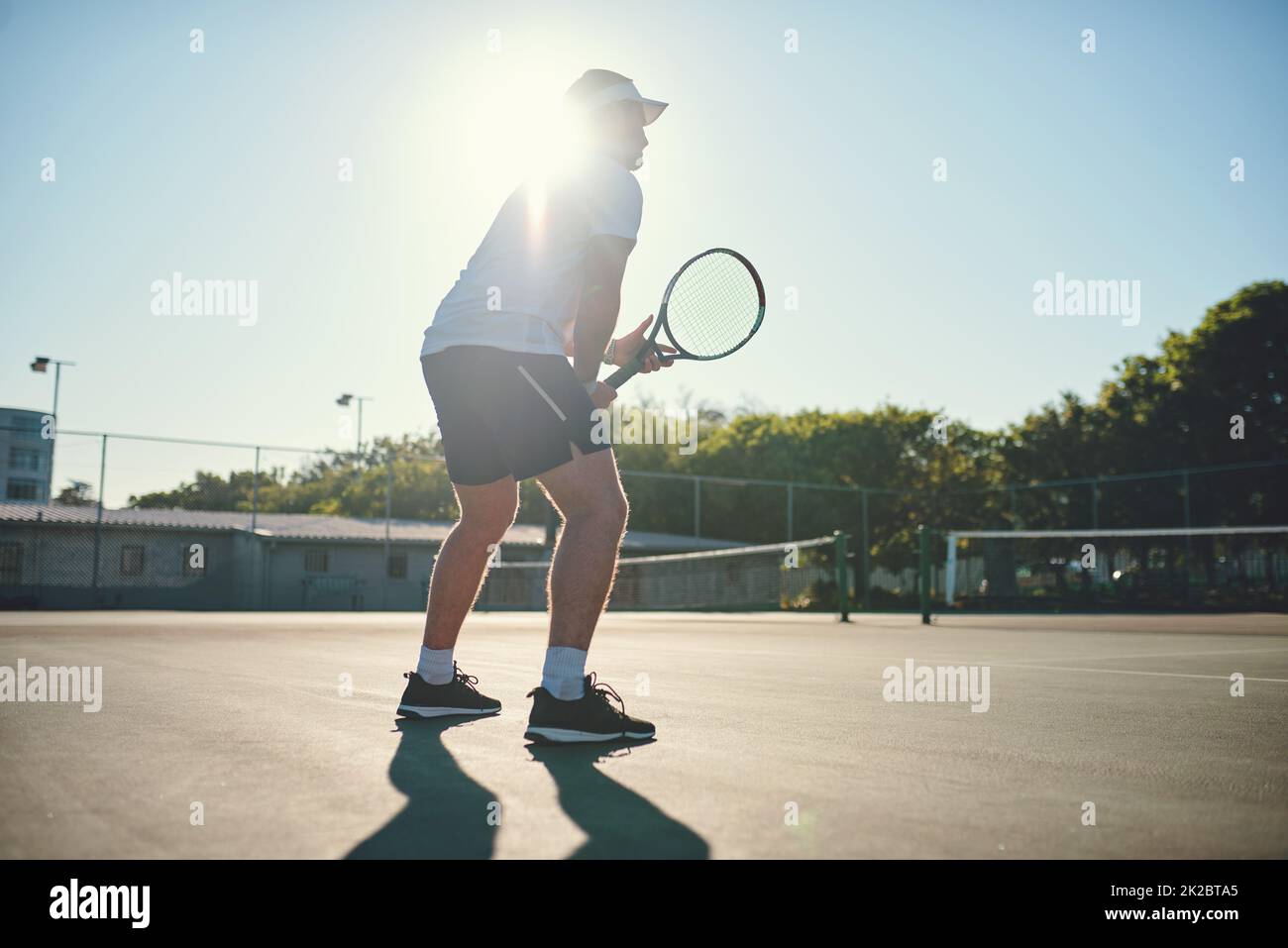 Be fair and play hard. Shot of a sporty young man playing tennis on a tennis court. Stock Photo
