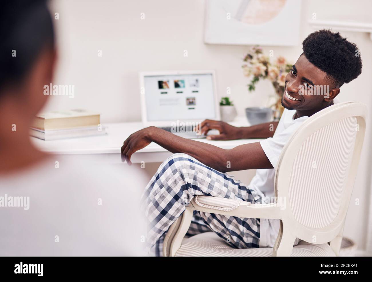 Hes up to no good online. Defocused shot of a young man using a laptop at home. Stock Photo