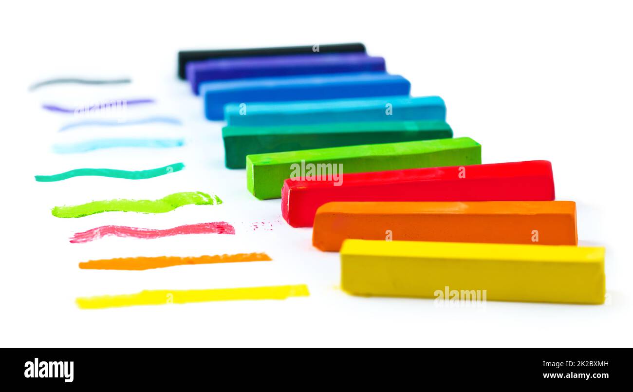Get creative with color. A line of chalk in many colors on a white background. Stock Photo