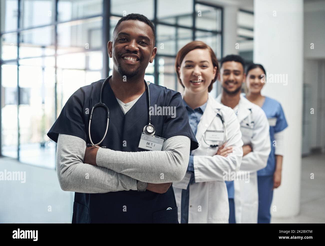 Not all heroes wear capes some wear labcoats. Shot of a group of medical staff together at work. Stock Photo