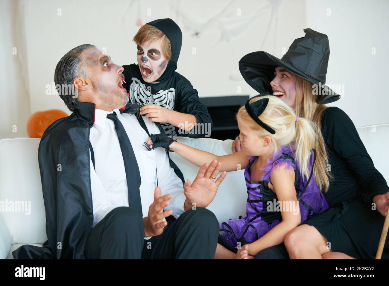 Best time of the year for frights. A cute family dressed up for Halloween all trying to scare each other. Stock Photo