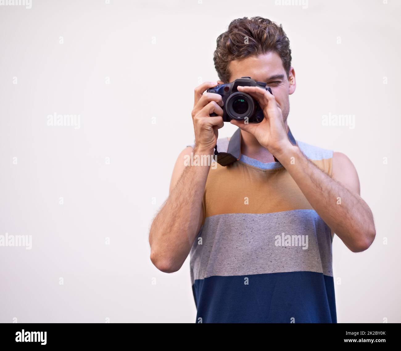 Hes got you framed. Young man taking a photograph of you. Stock Photo