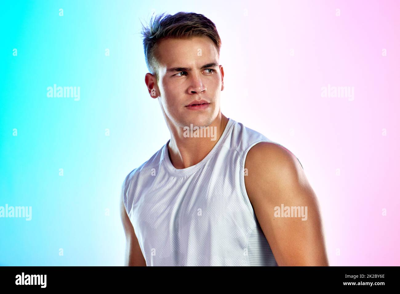 Lets get this workout started. Studio shot of a handsome young male athlete posing against a multi-coloured background. Stock Photo