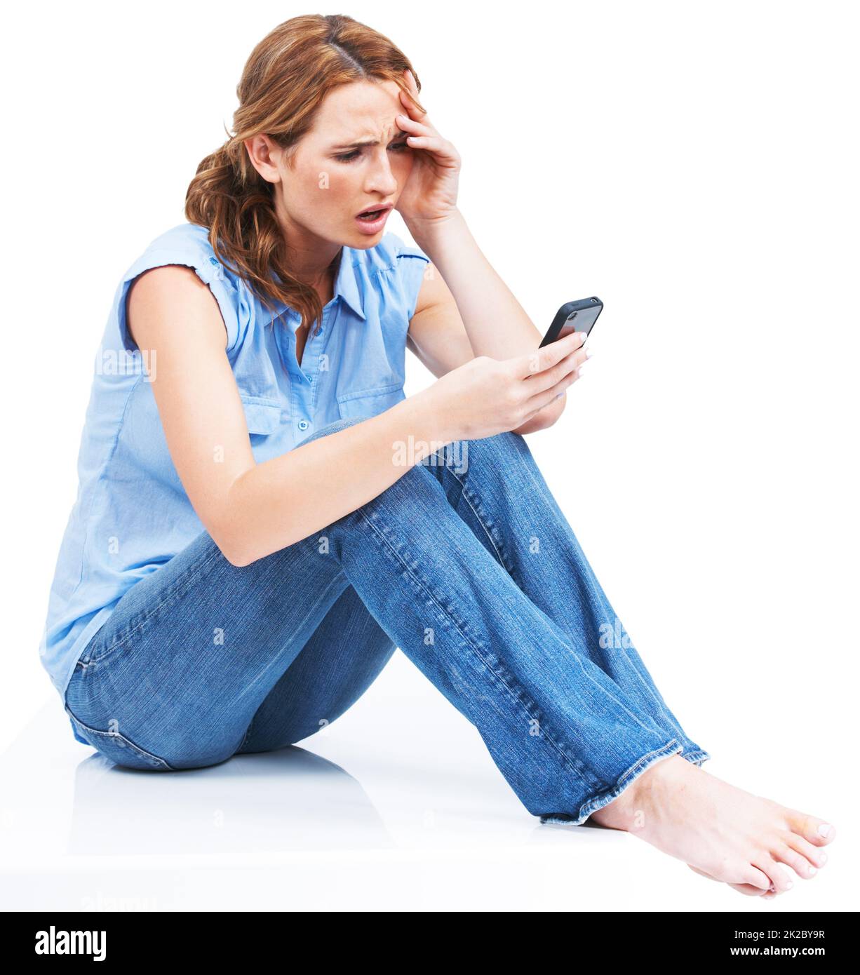Breakups are hard to take - Relationships. Beautiful young woman reading a text message in disbelief. Stock Photo
