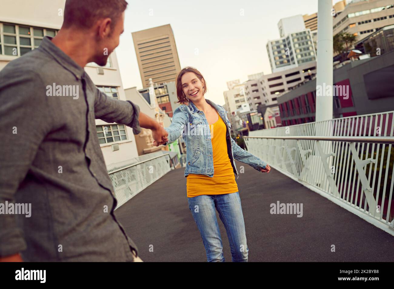 Romantic city strolls. Shot of a happy young couple enjoying a romantic walk together in the city. Stock Photo