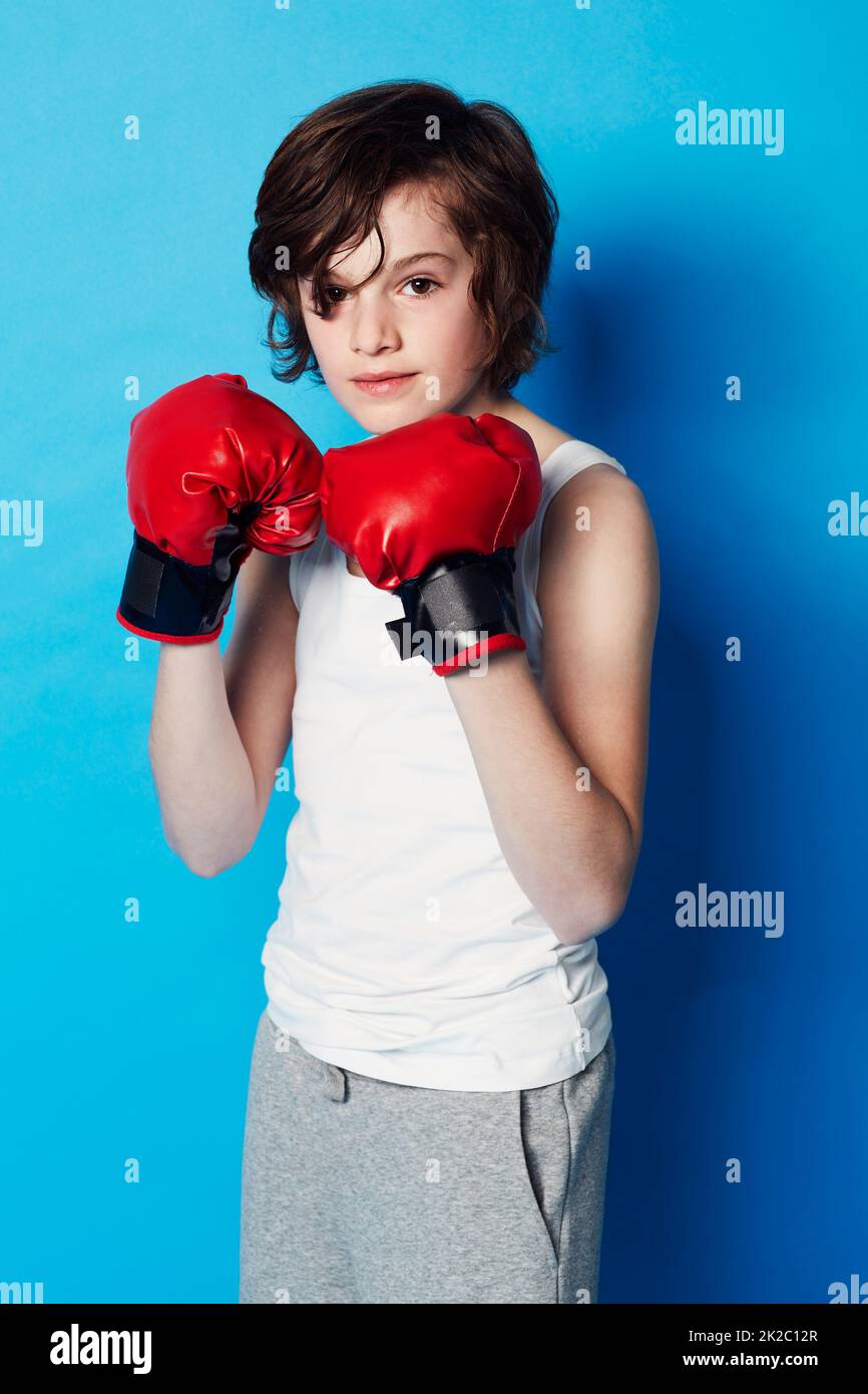 Ive got a big fight coming up. Portrait of a young boy wearing boxing ...