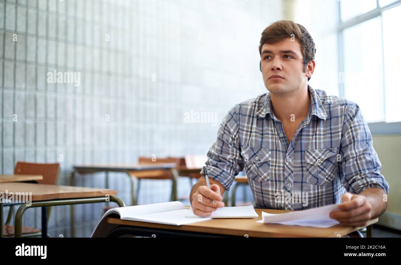 Dedicated to his education. Shot of a young college student studying in class. Stock Photo