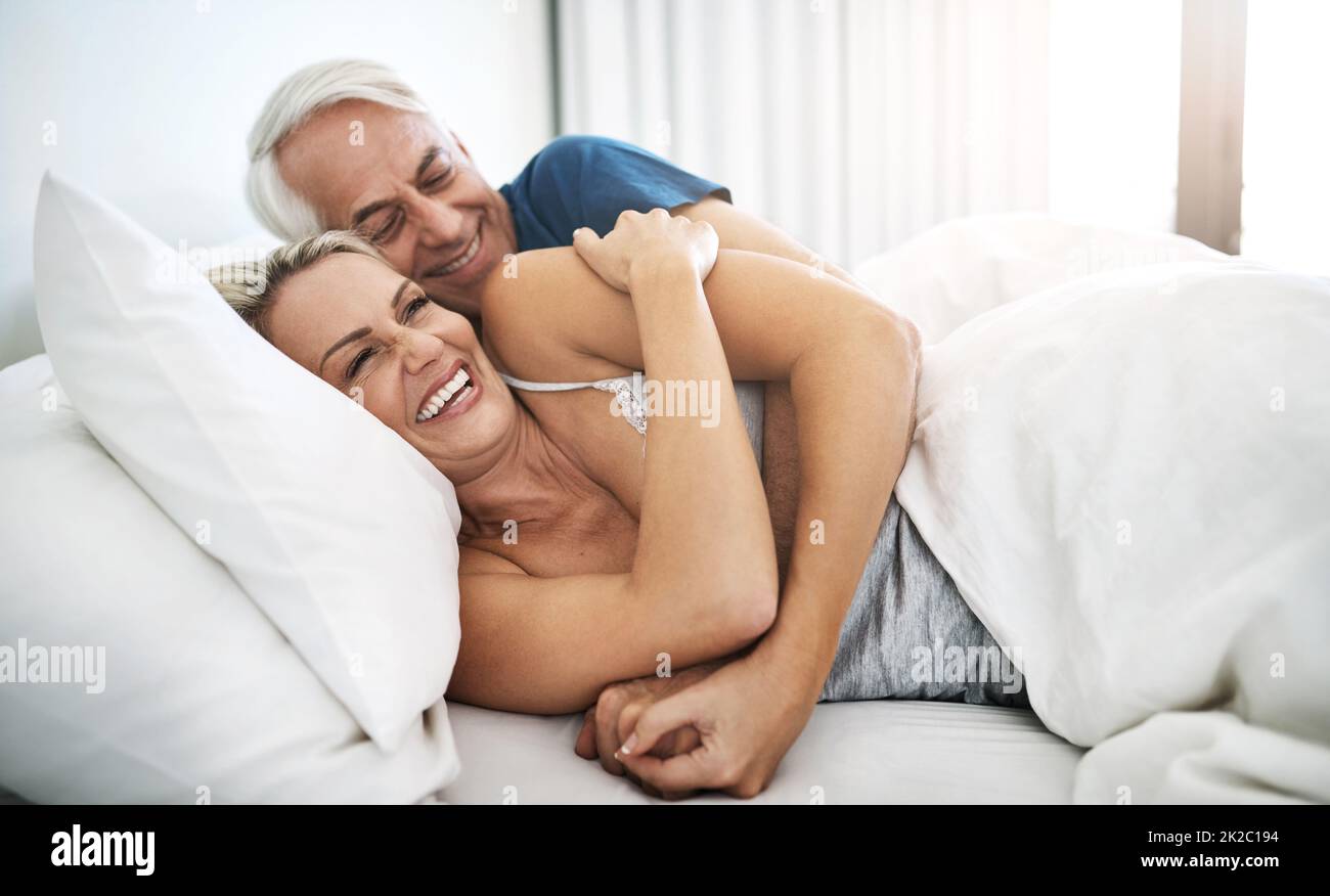 Mature couple lying in bed hi-res stock photography and images picture