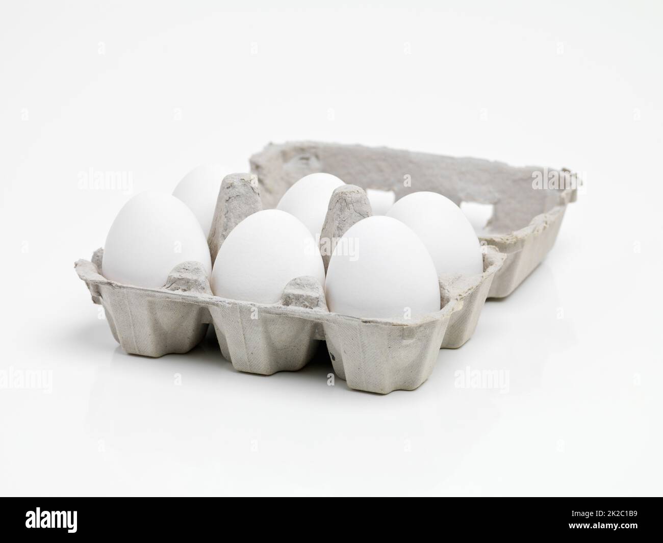 Ready to make an awesome breakfast. Studio shot of half a dozen white eggs in a carton. Stock Photo