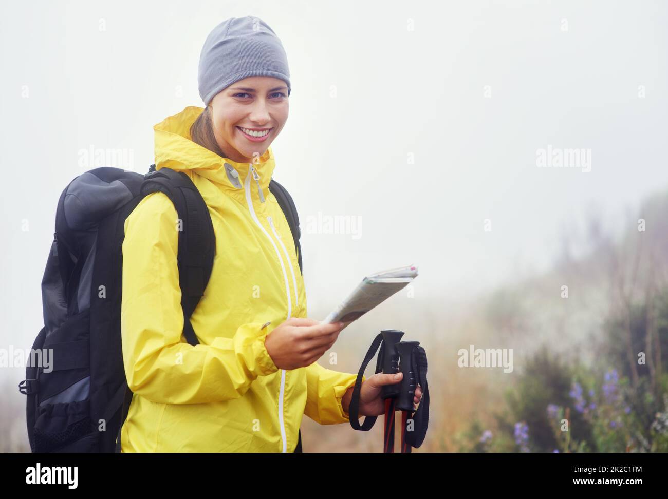 Which route shall I do today. Portrait of an attractive young woman standing in her hiking gear and holding a map. Stock Photo
