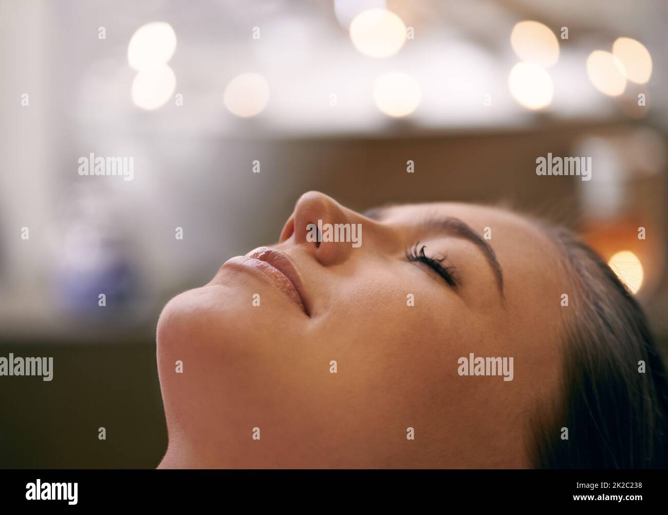 Total relaxation. Closeup of a young womans face during a massage. Stock Photo
