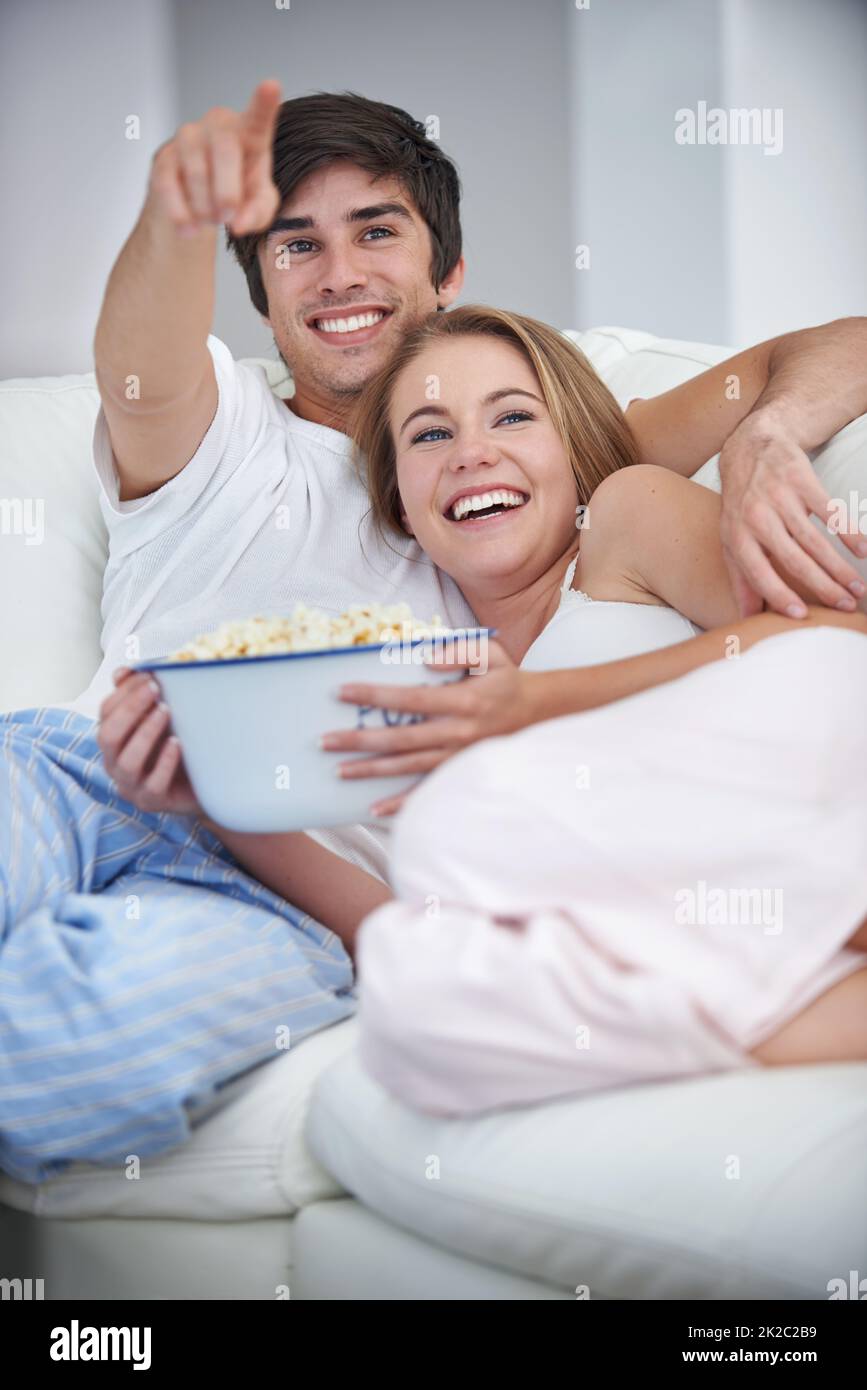 Movie night. A young couple watching a movie at home. Stock Photo