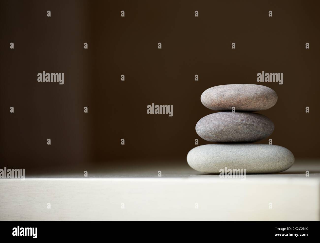 Find your balance. Three stones balanced on top of each other in natural light. Stock Photo