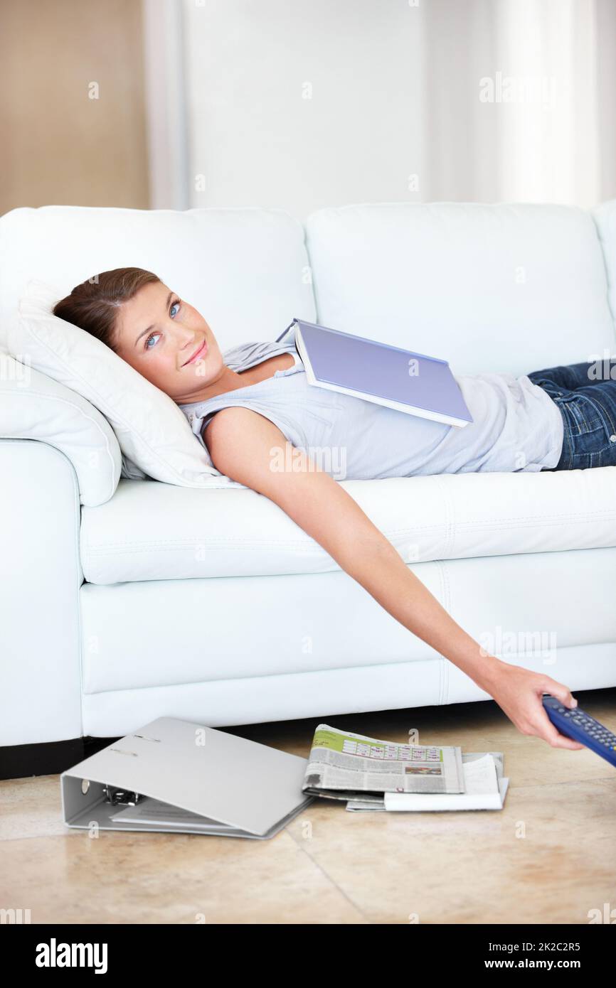 Taking a much needed study break. Smiling young student lying on the