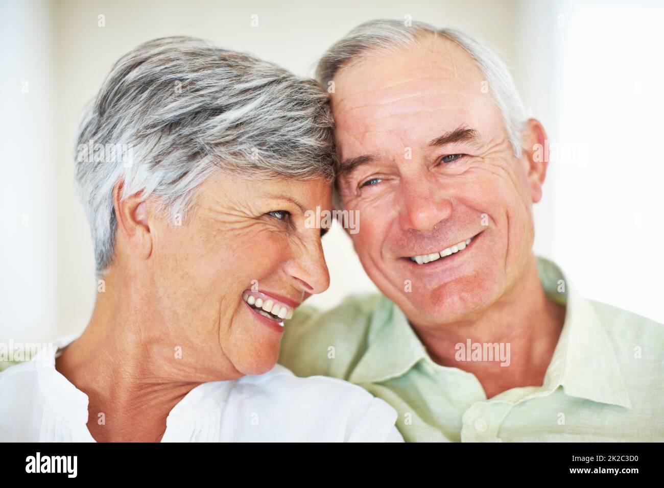 Loving mature couple at home. Closeup of loving mature couple spending quality time together. Stock Photo
