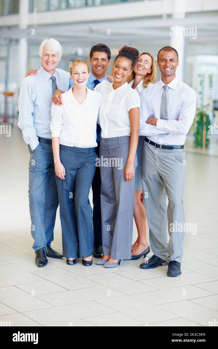 Happy business group. Full length of happy multi ethnic business group together at office. Stock Photo