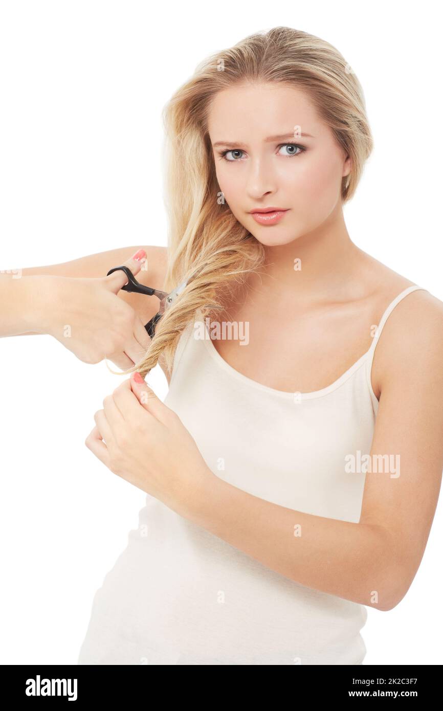 Its time for a change. A unsure young beauty about to chop of her hair. Stock Photo