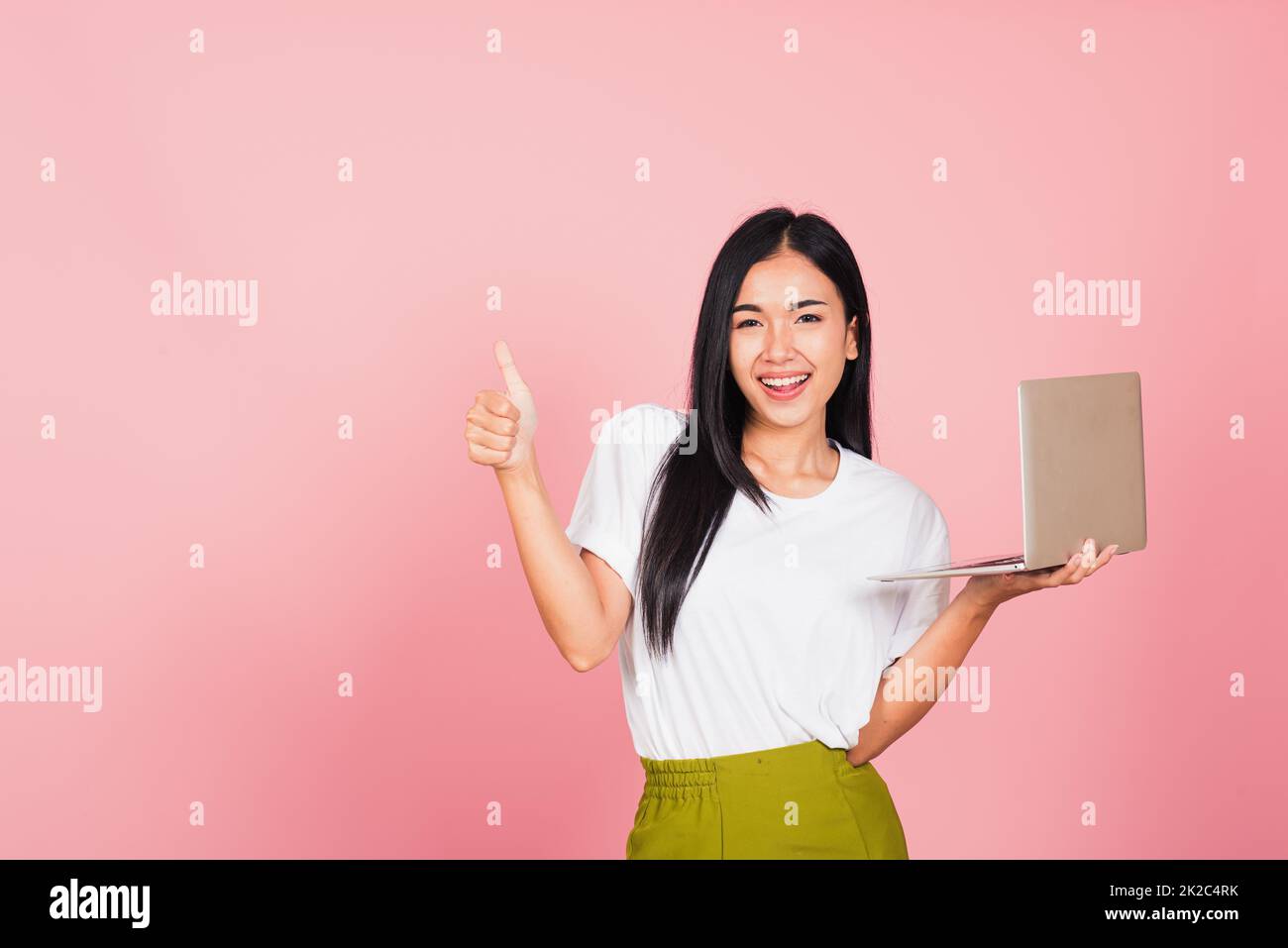 woman confident smiling holding using laptop computer and showing thumb ...