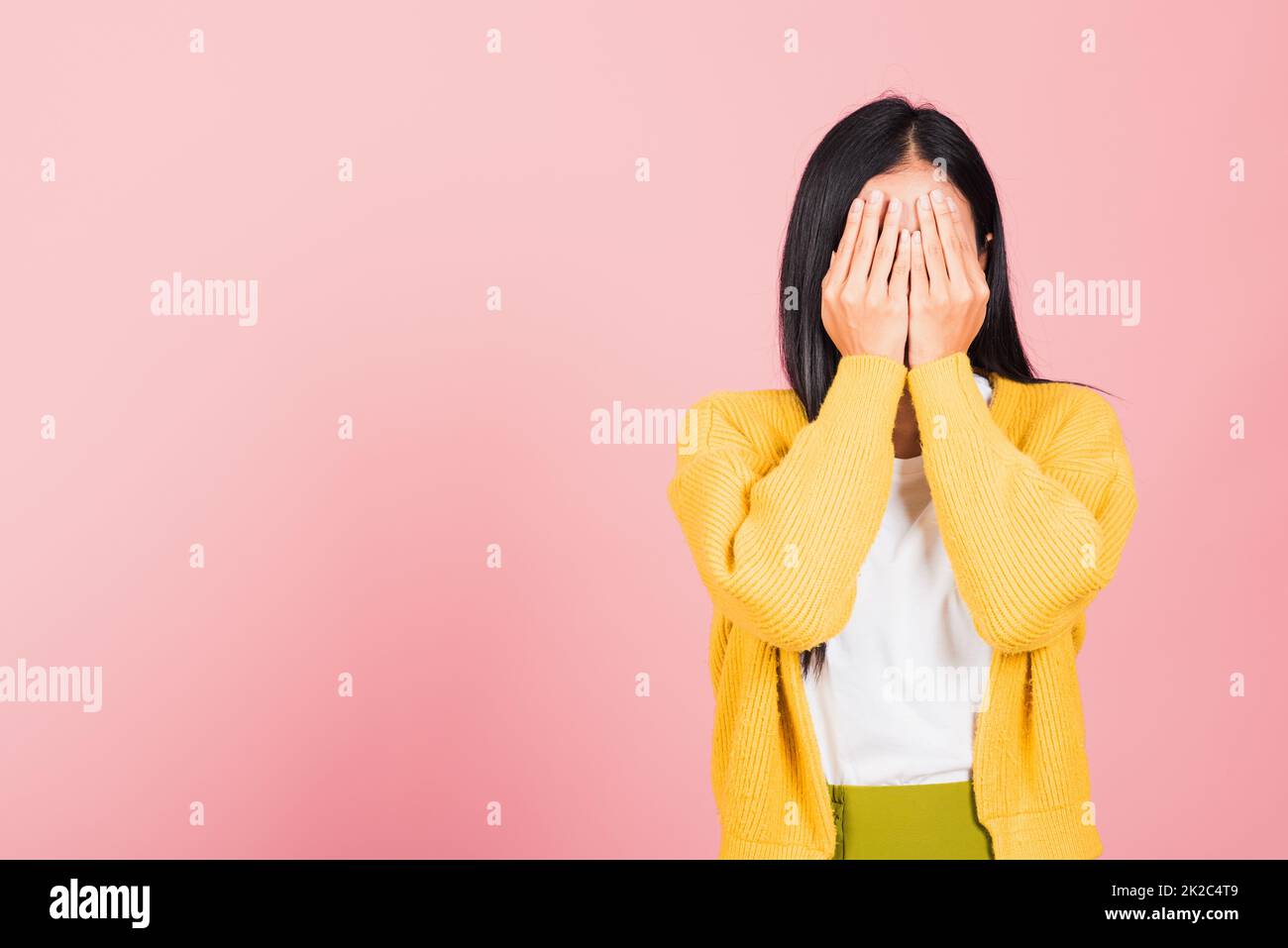 young woman in depressed bad mood her cry close face by hands Stock Photo