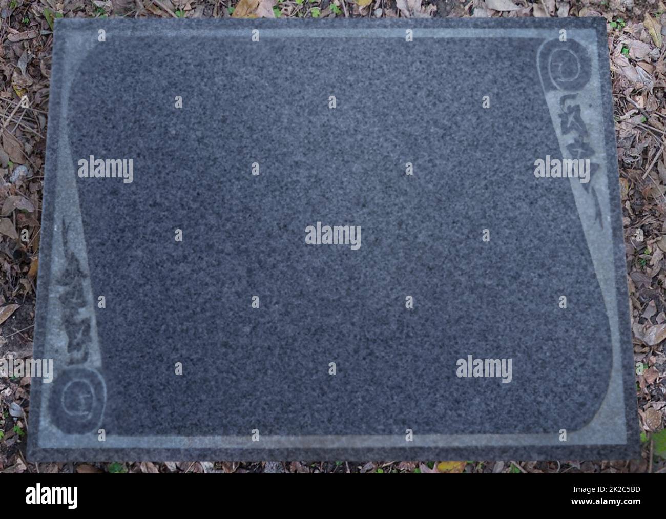 An empty headstone waiting for its epitaph. Shot of a gravestone in a cemetery. Stock Photo