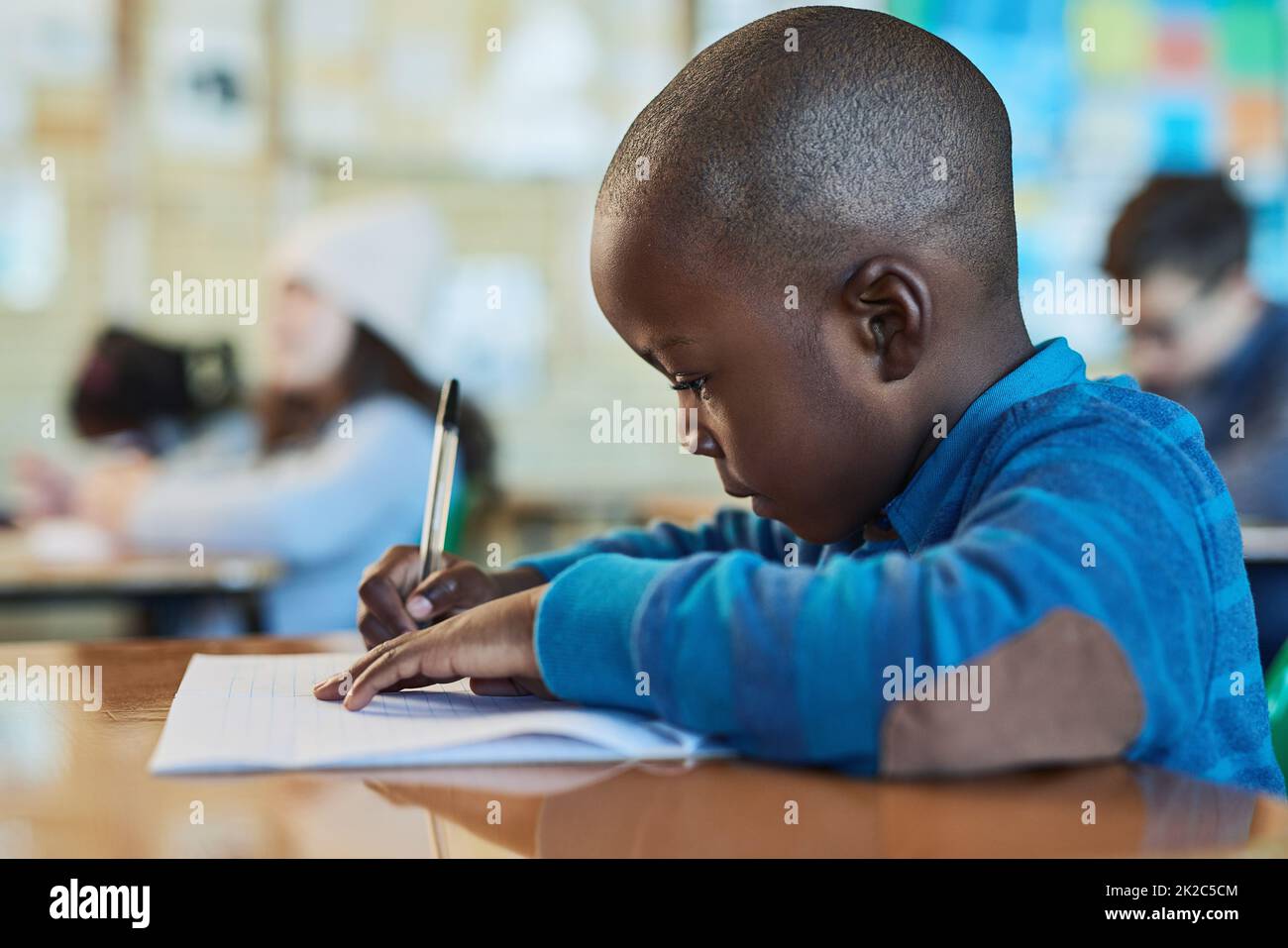Bright young minds. Shot of an elementary school boy working in class. Stock Photo