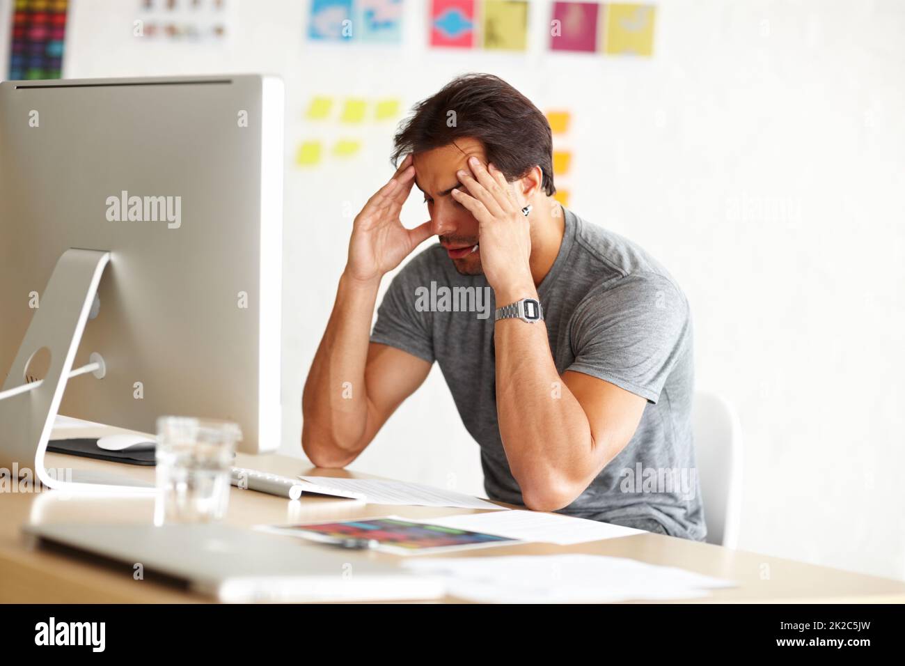 Exhaustion kills creativity. An overwhelmed man sitting at an office