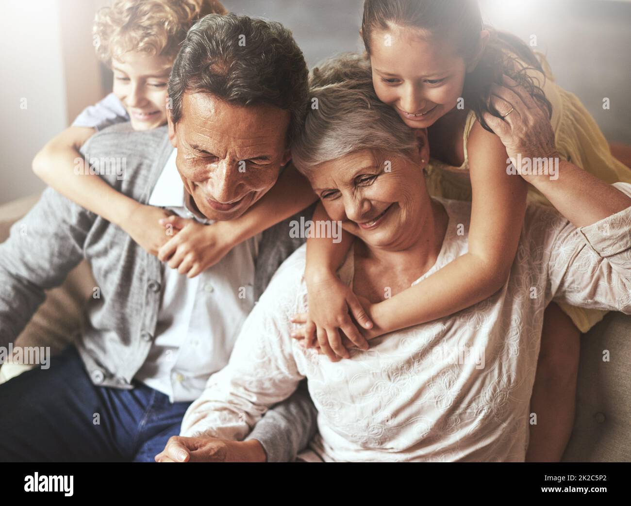 Grandchildren are a blessing. Shot of grandparents spending time with their grandchildren at home. Stock Photo