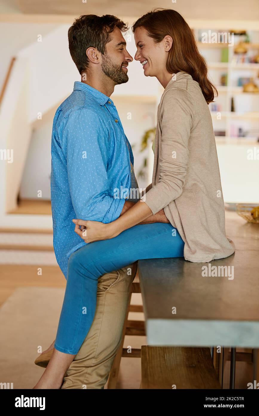 You are my everything. Cropped shot of an affectionate young couple face to face in their kitchen. Stock Photo