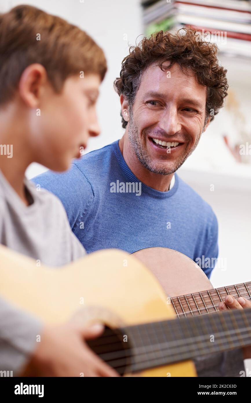 Father teaching teen son guitar hi-res stock photography and images - Alamy