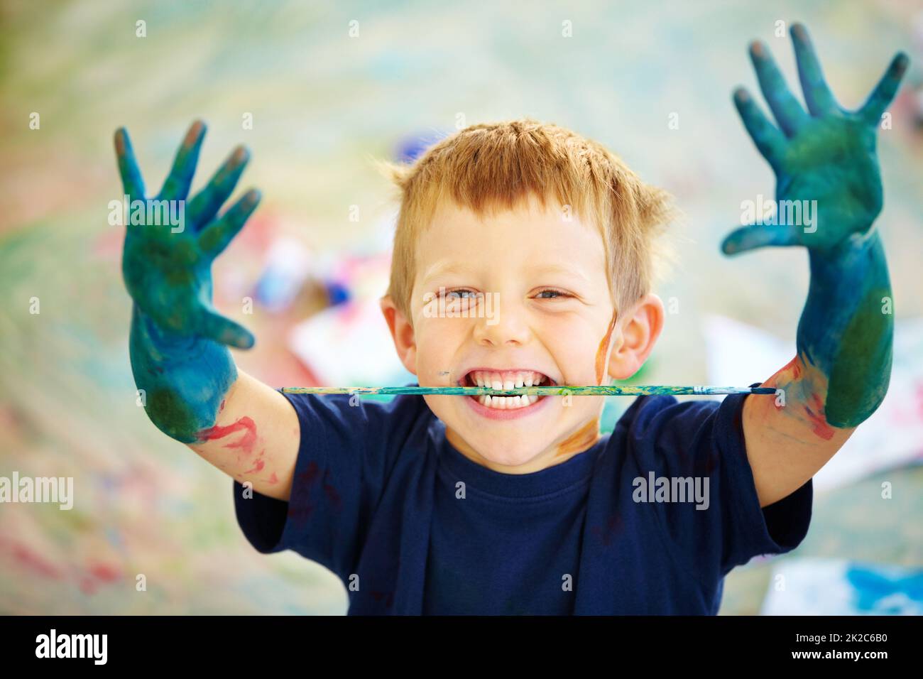 Messy little artist. A little boy covered in paint. Stock Photo