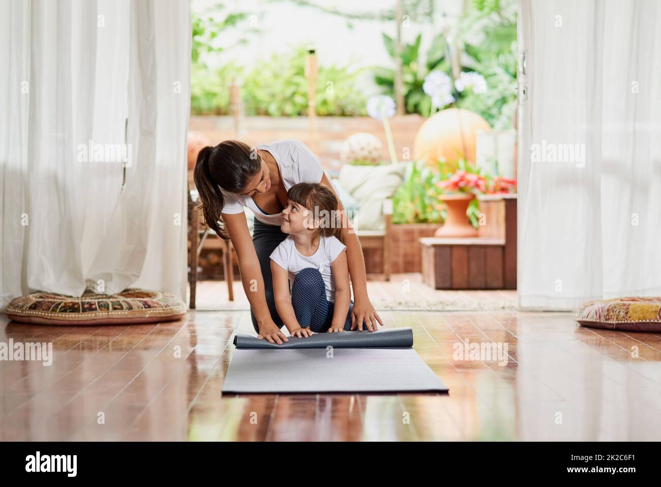 teaching-my-daughter-step-by-step-shot-of-a-cheerful-young-mother-and