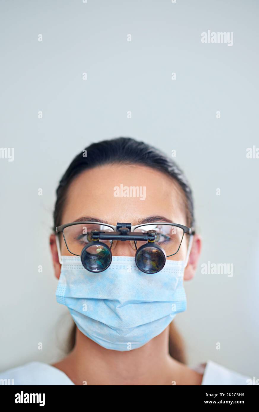 Lets take a closer look. Portrait of a young female dentist wearing