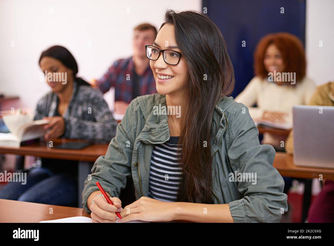 Achieving my goals a semester at a time. Shot of a happy student paying attention in class. Stock Photo