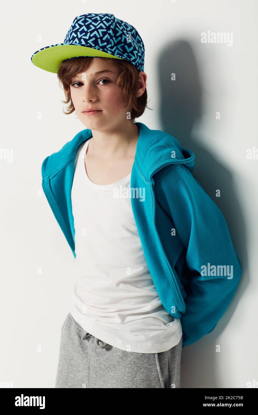 Moody blue. Cute preteen boy wearing trendy clothing while isolated on white. Stock Photo