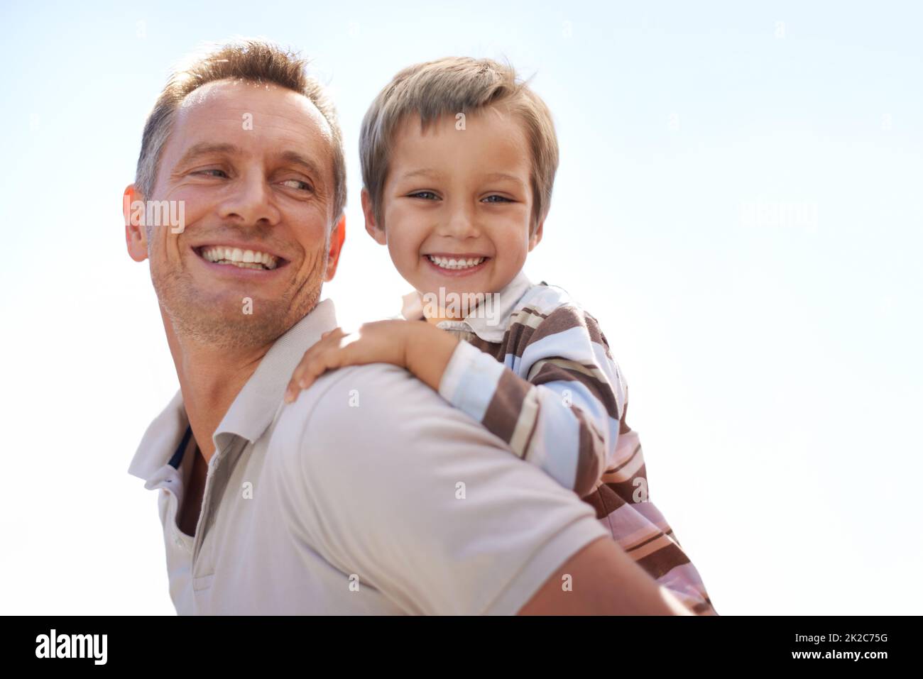 Father and son adventure. Shot of a father piggybacking his young son. Stock Photo