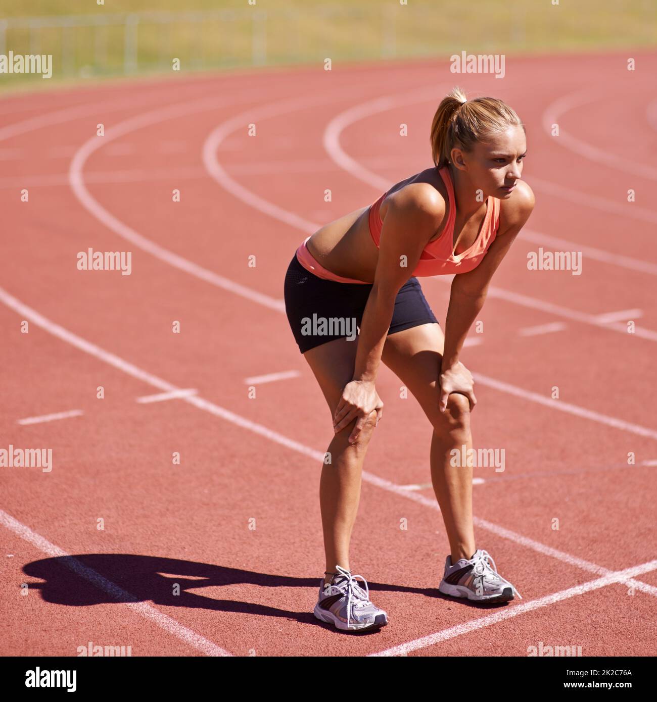 Ready for a race. Shot of an attractive young runner out on the track. Stock Photo