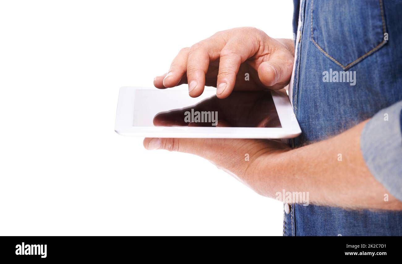 Going online just got a little bit easier.... Cropped image of a man holding a digital tablet isolated on white. Stock Photo