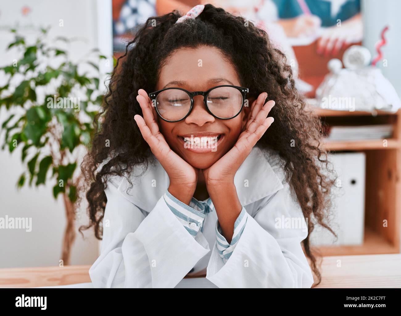 Why didnt anyone tell me science is so much fun. Portrait of an adorable young school girl feeling cheerful in science class at school. Stock Photo