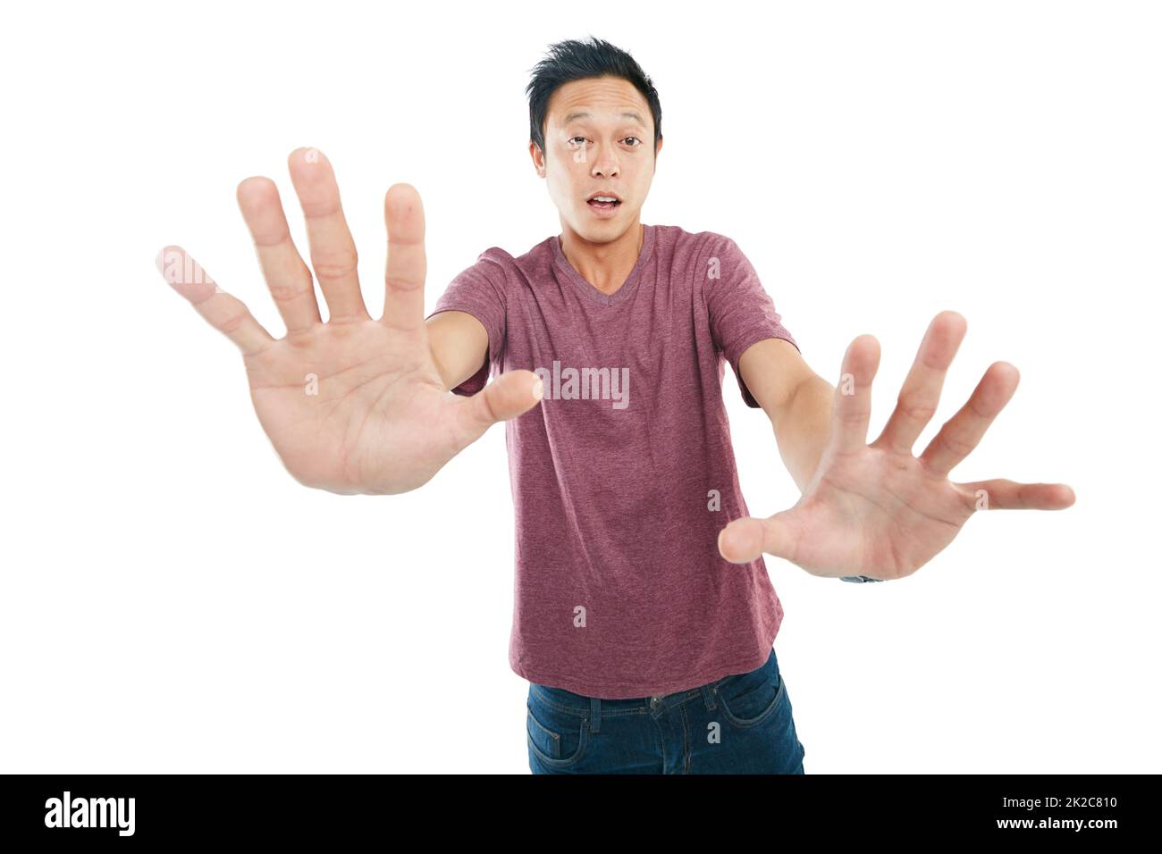 Studio portrait of a young man feeling dizzy against a white background