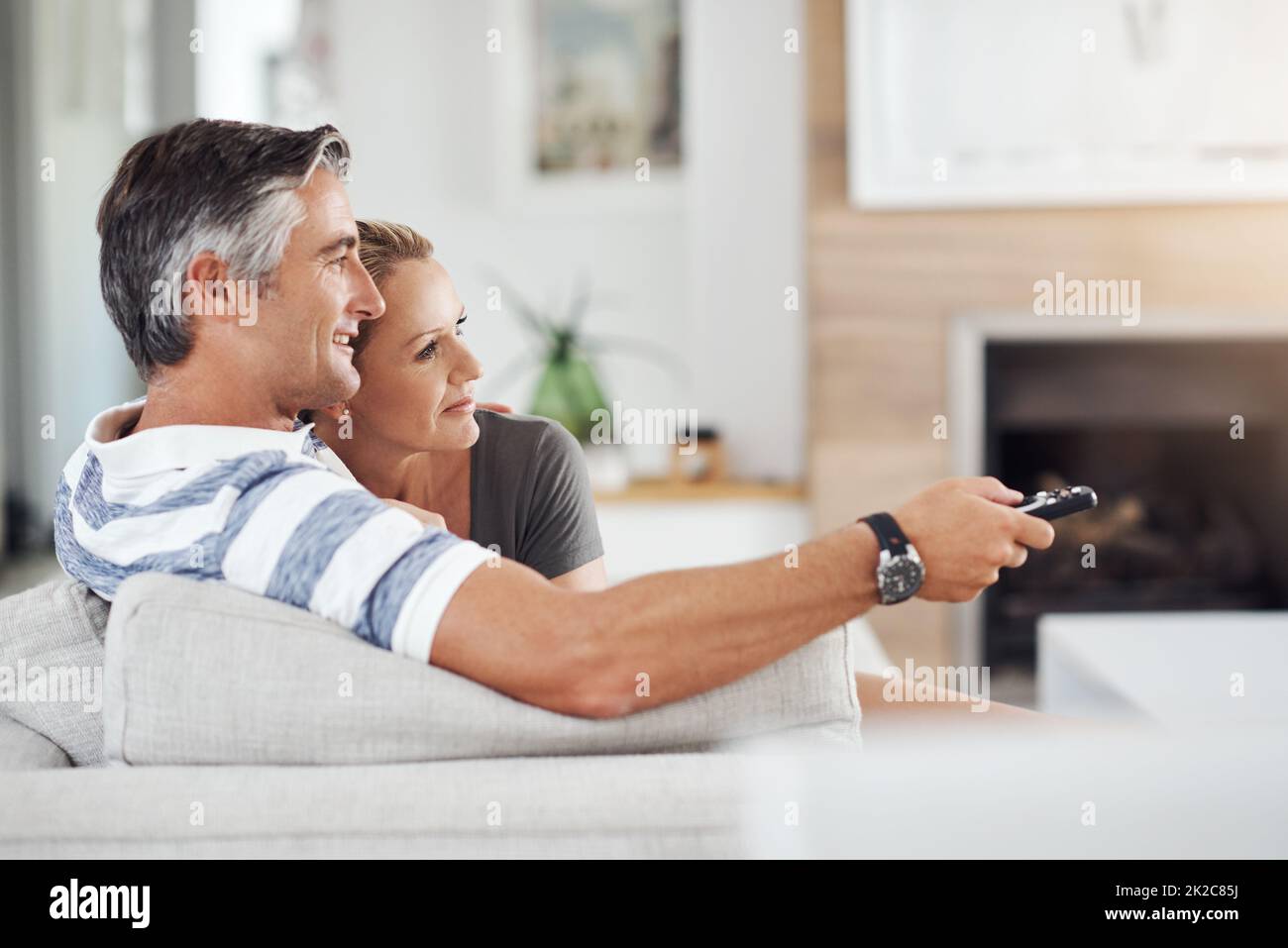 Man woman mature watching tv sofa hires stock photography and images