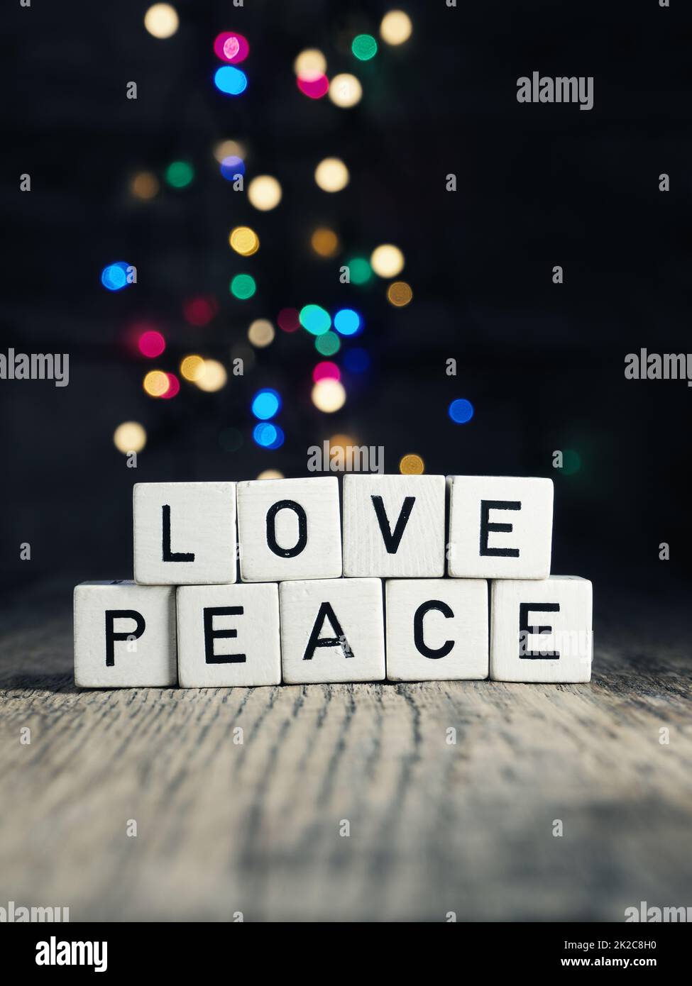 Wooden cube with inscription love and peace Stock Photo
