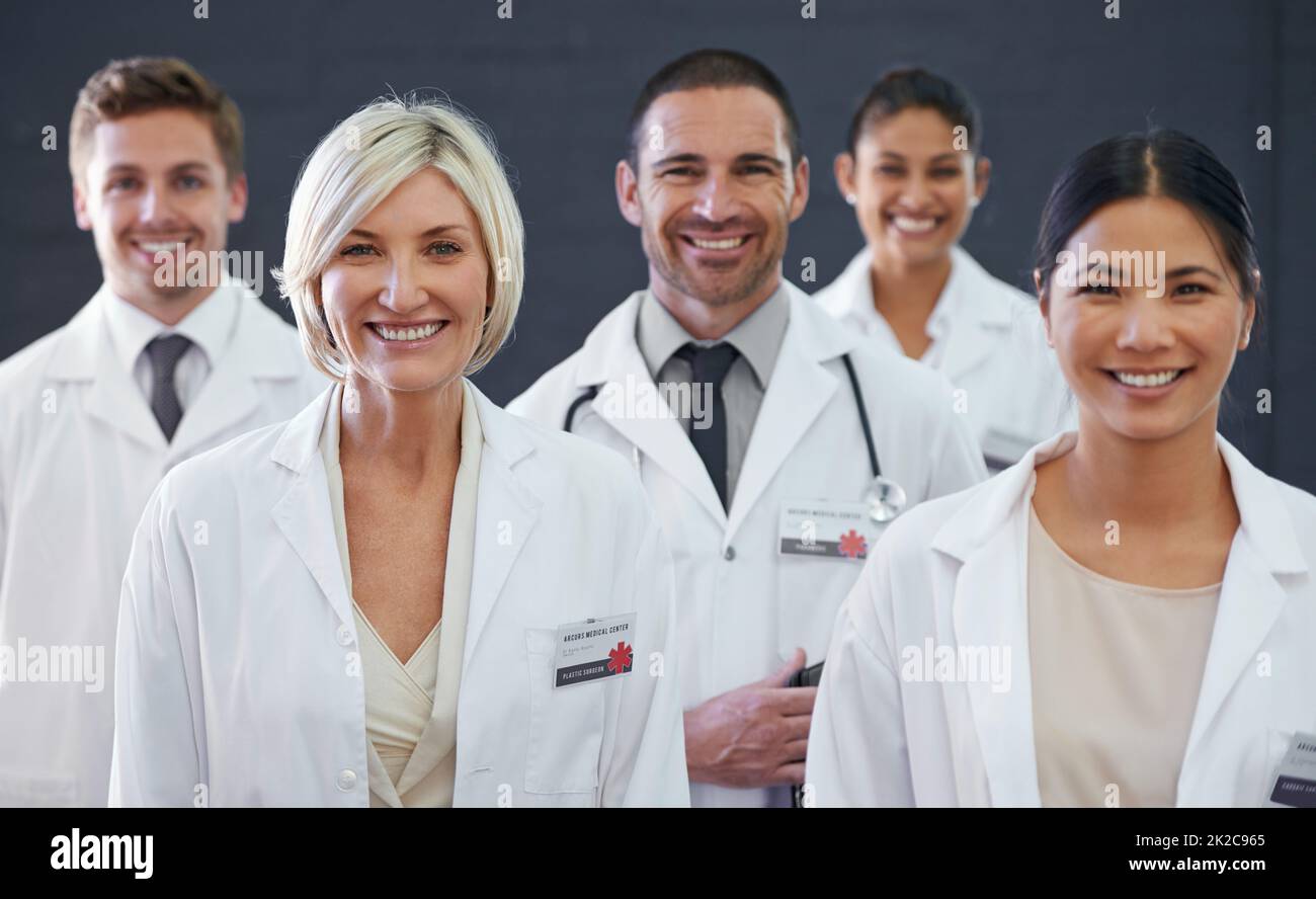 Medicines finest. Studio portrait of a team of doctors standing against a grey background. Stock Photo