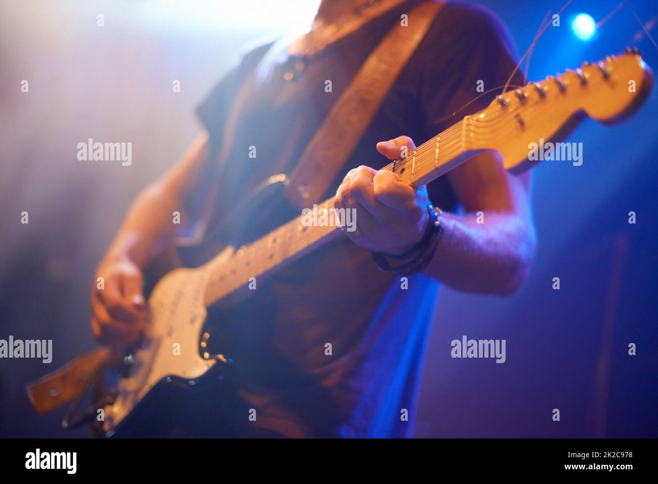 Hitting the right notes. A guitarist playing his heart out beneath the