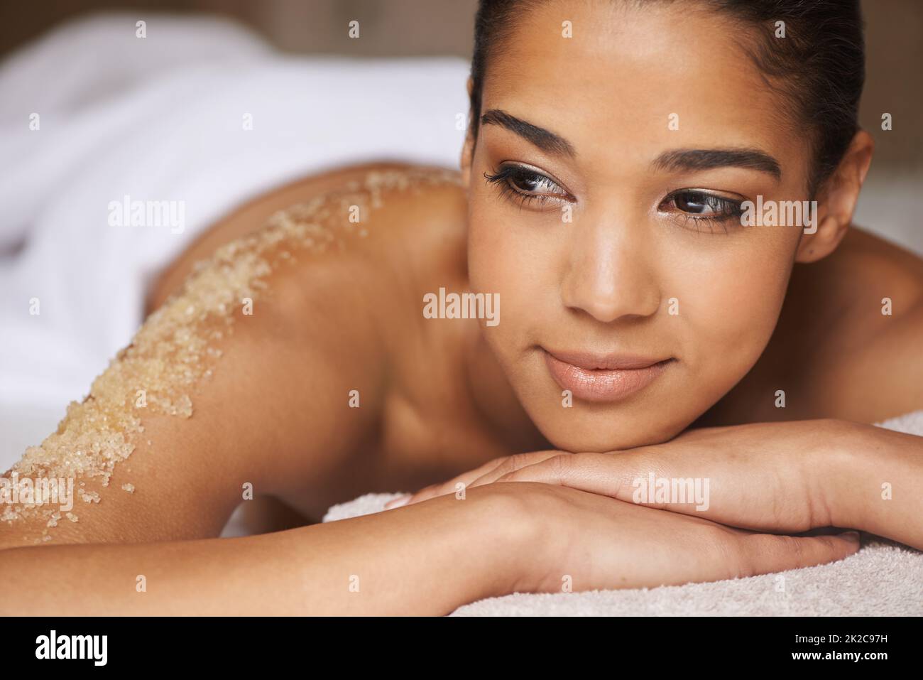 Total body exfoliation. Closeup shot of a young woman relaxing during a spa treatment. Stock Photo