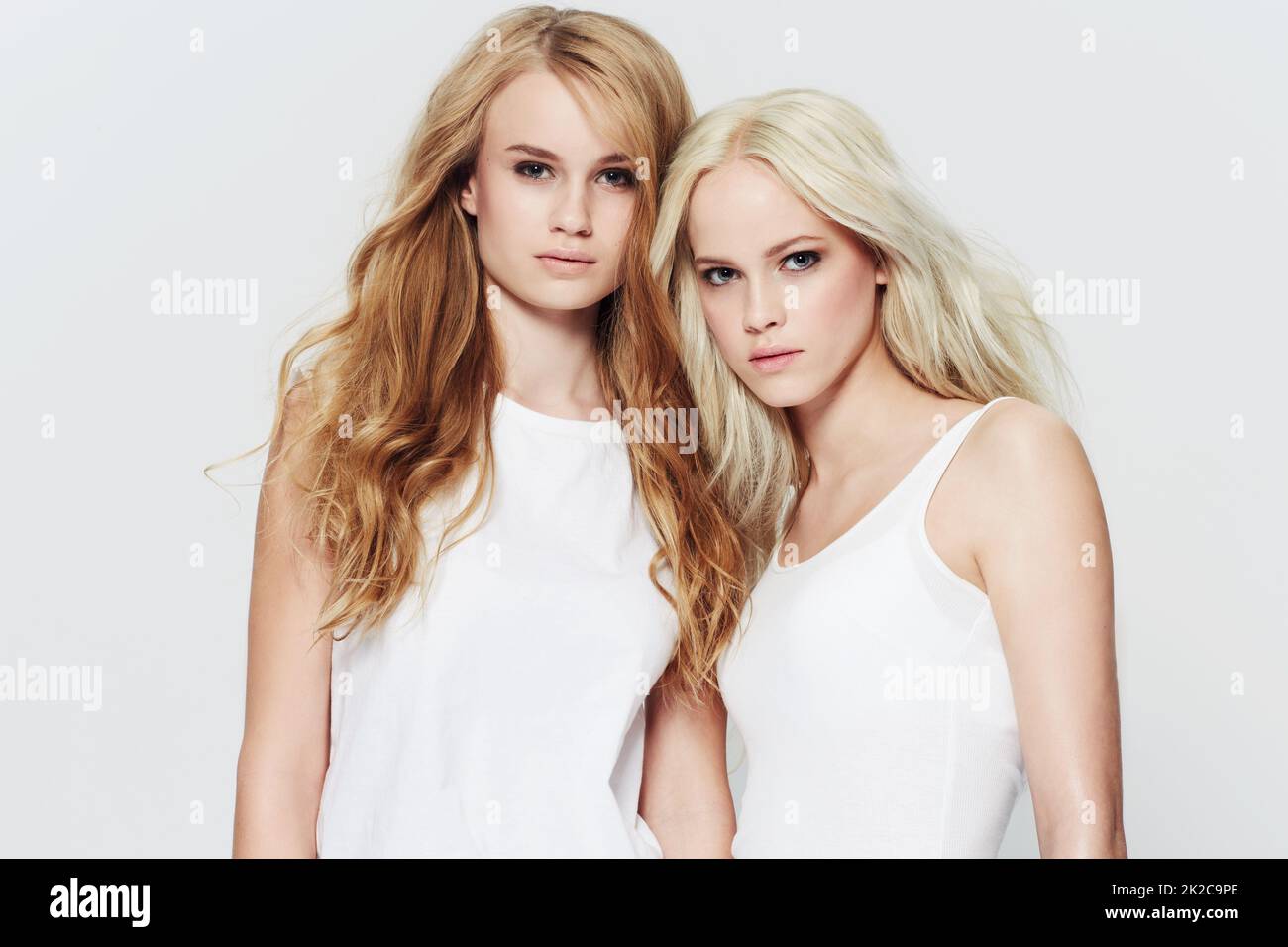 Looking naturally beautiful. Studio portrait of two young models against a white background. Stock Photo