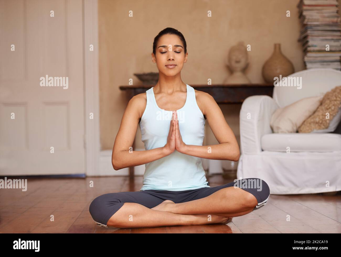 Woman doing yoga meditation watching online fitness session