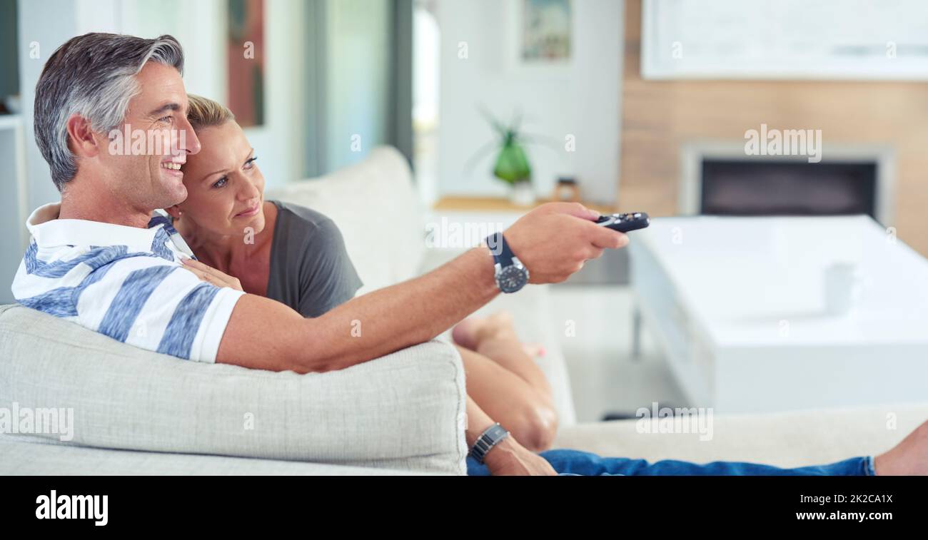 Shot of mature couple cuddling on the sofa while watching movies at home Stock Photo Alamy