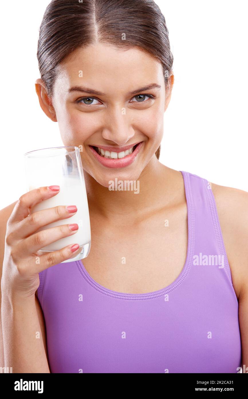 Keep calm and drink milk. Portrait of a beautiful woman holding a glass of milk. Stock Photo