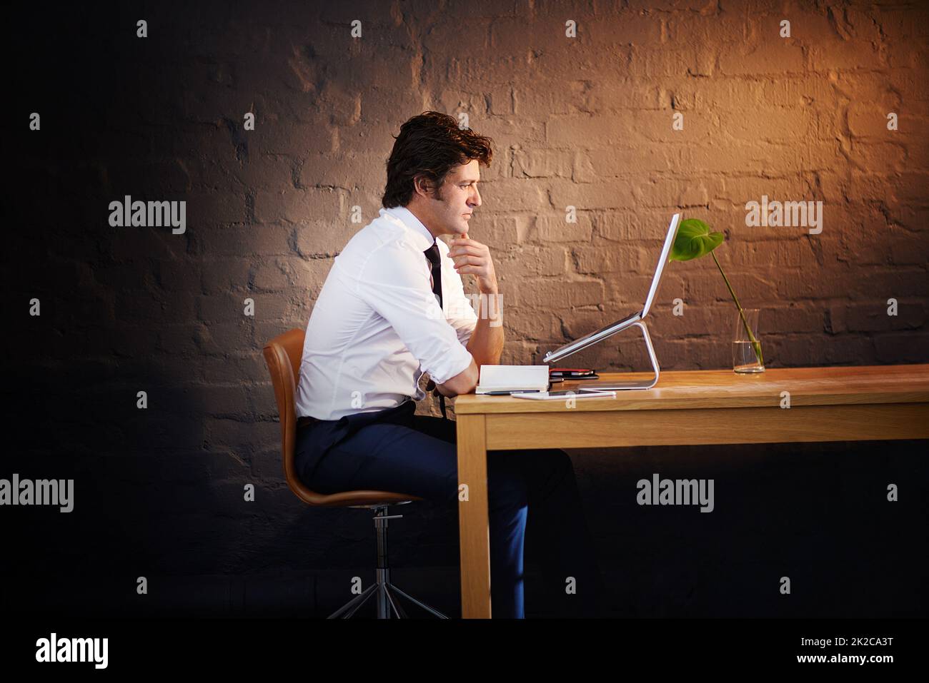 First one to arrive, last one to leave. Shot of a businessman working late at the office. Stock Photo